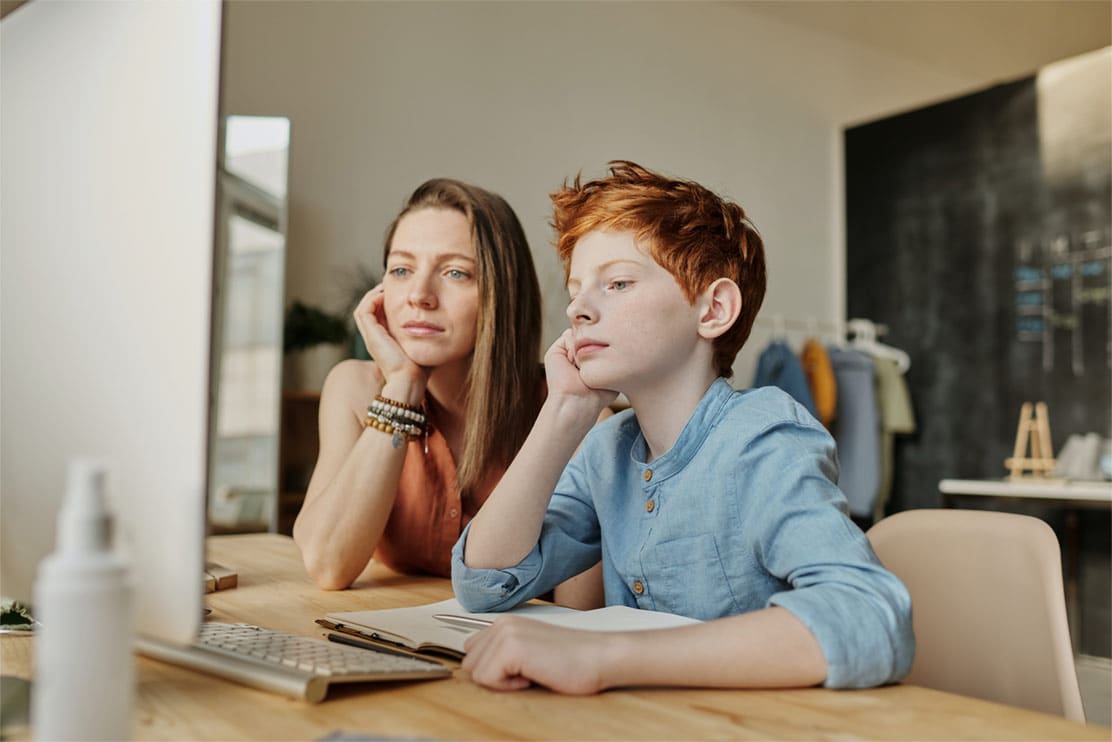 photo-of-woman-and-boy-leaning-on-table-1